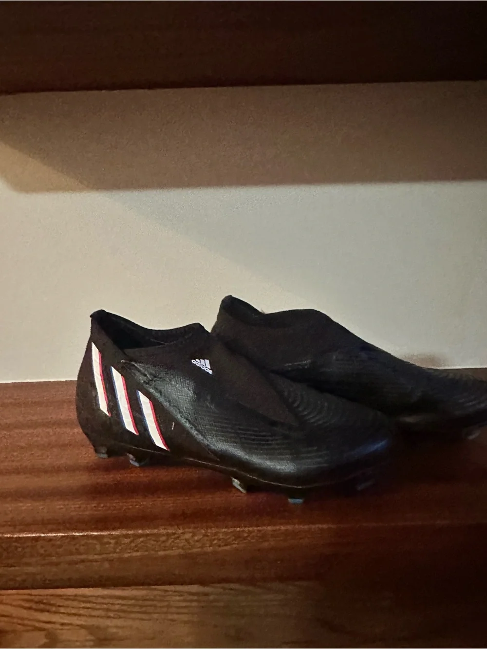 adidas Black Soccer Cleat with Blue and Red Stripe Accents